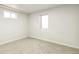 Unfinished basement with neutral paint, carpet, and two windows at 315 S Xapary St, Aurora, CO 80012