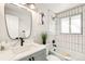 Modern bathroom features a sleek vanity, updated fixtures, and a tiled shower/tub combination at 315 S Xapary St, Aurora, CO 80012