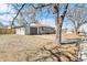 View of a single-story home, detached garage and spacious driveway surrounded by a well-maintained yard at 315 S Xapary St, Aurora, CO 80012