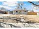 Charming single-story home with a well-maintained front yard, driveway, and detached garage at 315 S Xapary St, Aurora, CO 80012