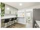 Bright kitchen featuring gray cabinets, stainless steel appliances, and a breakfast bar with seating at 315 S Xapary St, Aurora, CO 80012