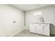 Laundry room with ample storage space and modern fixtures at 315 S Xapary St, Aurora, CO 80012