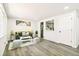 Bright and airy living room featuring neutral walls, wood-look floors, and an open layout at 315 S Xapary St, Aurora, CO 80012