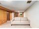 Spacious finished basement featuring neutral carpet, and exposed brick wall at 3225 W Mexico Ave, Denver, CO 80219