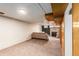 Wide angle showcasing finished basement with brick fireplace and modern wood elements at 3225 W Mexico Ave, Denver, CO 80219