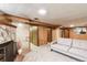 Finished basement with cozy fireplace, wood-paneled walls, and comfortable seating at 3225 W Mexico Ave, Denver, CO 80219