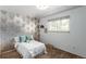 Bedroom featuring a large window and unique wallpaper with a comfy bed at 3225 W Mexico Ave, Denver, CO 80219