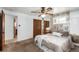 Bright bedroom with ceiling fan, neutral carpet and mirrored wall; bathroom and closet in view at 3225 W Mexico Ave, Denver, CO 80219