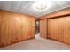 Bedroom with carpeted floors, wood paneled walls, and ample closet space at 3225 W Mexico Ave, Denver, CO 80219