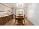 Cozy dining room featuring wood floors, bright light, and a view into yard at 3225 W Mexico Ave, Denver, CO 80219