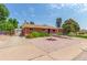 Single story brick home featuring drive way, gravel landscaping, and mature bushes at 3225 W Mexico Ave, Denver, CO 80219