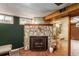 Close up of the stone fireplace with brick surround and a decorative accent wall at 3225 W Mexico Ave, Denver, CO 80219