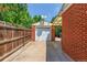 Exterior view of a one-car garage with white door and brick construction at 3225 W Mexico Ave, Denver, CO 80219