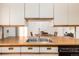 Bright kitchen featuring a stainless steel sink, light countertops, and ample cabinet space at 3225 W Mexico Ave, Denver, CO 80219