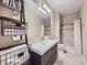 Stylish bathroom with a modern vanity, mirror, decorative ladder, and tiled shower at 424 N De Gaulle Ct, Aurora, CO 80018