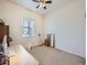 Clean and bright bedroom featuring a neutral color scheme, large window and a desk at 424 N De Gaulle Ct, Aurora, CO 80018