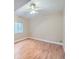 Bright bedroom featuring hardwood floors, a ceiling fan, and a window for natural light at 424 N De Gaulle Ct, Aurora, CO 80018