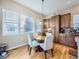 Bright breakfast nook with a round table and chairs, surrounded by windows and wood cabinetry at 424 N De Gaulle Ct, Aurora, CO 80018