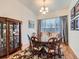 Elegant dining room featuring hardwood floors, a large window, and seating for eight at 424 N De Gaulle Ct, Aurora, CO 80018