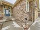 Attractive front entrance with stone veneer, stylish blue door and manicured landscaping at 424 N De Gaulle Ct, Aurora, CO 80018