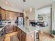 Open-concept kitchen with stainless steel appliances and a central island, flowing into the living room at 424 N De Gaulle Ct, Aurora, CO 80018