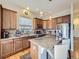 Modern kitchen with stainless steel appliances, a large island, and custom cabinetry at 424 N De Gaulle Ct, Aurora, CO 80018