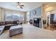 Cozy living room features a fireplace, neutral tones, and lots of natural light at 424 N De Gaulle Ct, Aurora, CO 80018