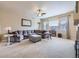 Spacious living room with plush carpeting, ceiling fan, and large windows at 424 N De Gaulle Ct, Aurora, CO 80018