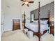 Spacious main bedroom featuring a four-poster bed, accent wall, and traditional furniture at 424 N De Gaulle Ct, Aurora, CO 80018