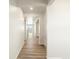 Bright hallway with wood-look flooring leading to other rooms at 6156 Hourglass Dr, Brighton, CO 80601