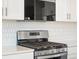 Stainless steel gas range with a built-in microwave above at 6156 Hourglass Dr, Brighton, CO 80601