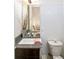 Modern bathroom with a single sink vanity, toilet and updated fixtures at 903 E 13Th Ave, Denver, CO 80218