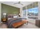 Spacious bedroom with large windows, city views, and a wooden bench at 903 E 13Th Ave, Denver, CO 80218