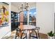 Bright dining area with a round table, four chairs, and a large window at 903 E 13Th Ave, Denver, CO 80218