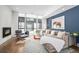 Relaxing living area featuring a sectional sofa, fireplace, and large windows at 903 E 13Th Ave, Denver, CO 80218