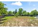 Wide, fenced backyard with mature landscaping and plentiful sunshine at 272 Lafayette St, Louisville, CO 80027