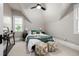 Cozy bedroom with sloped ceilings, plush carpet, and a comfortable bed at 1019 26Th St, Denver, CO 80205