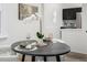 Eat-in kitchen and dining area features an elegant round table, stylish decor, and modern finishes at 1019 26Th St, Denver, CO 80205