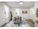 Bright dining area with modern rug, decorative tree art, and shear curtains creates a relaxing and welcoming space at 1019 26Th St, Denver, CO 80205