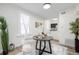 A cozy dining area next to the kitchen features hardwood floors, bright white walls, and contemporary furnishings at 1019 26Th St, Denver, CO 80205