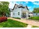 Charming two-story home with a light blue painted brick, covered porch, manicured lawn and professional landscaping at 1019 26Th St, Denver, CO 80205