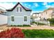 The exterior side of a beautiful light-blue two-story house is enhanced by a well-maintained lawn and lush landscaping at 1019 26Th St, Denver, CO 80205
