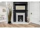 The fireplace features a decorative mantel and marble hearth, complemented by hardwood floors and decorative accents at 1019 26Th St, Denver, CO 80205