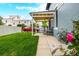 Charming covered front porch with seating area and a lovely flower bush, offering a welcoming curb appeal at 1019 26Th St, Denver, CO 80205