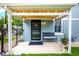 A cozy front porch with seating offers a welcoming entrance to this beautifully maintained light blue home at 1019 26Th St, Denver, CO 80205