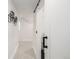 Hallway featuring a modern black sliding door and minimalist wall decor at 1019 26Th St, Denver, CO 80205