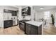 Modern kitchen features stainless steel appliances, including refrigerator and gas range, dark cabinets, and bright countertops at 1019 26Th St, Denver, CO 80205
