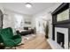 The bright living room boasts hardwood floors, a decorative fireplace, and comfortable seating, perfect for relaxing at 1019 26Th St, Denver, CO 80205