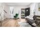 A light-filled living room with hardwood floors, a comfortable sofa, and a rocking chair, creating a cozy atmosphere at 1019 26Th St, Denver, CO 80205