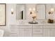 Elegant double vanity with white cabinets and quartz countertops at 66 Charlou Cir, Cherry Hills Village, CO 80111